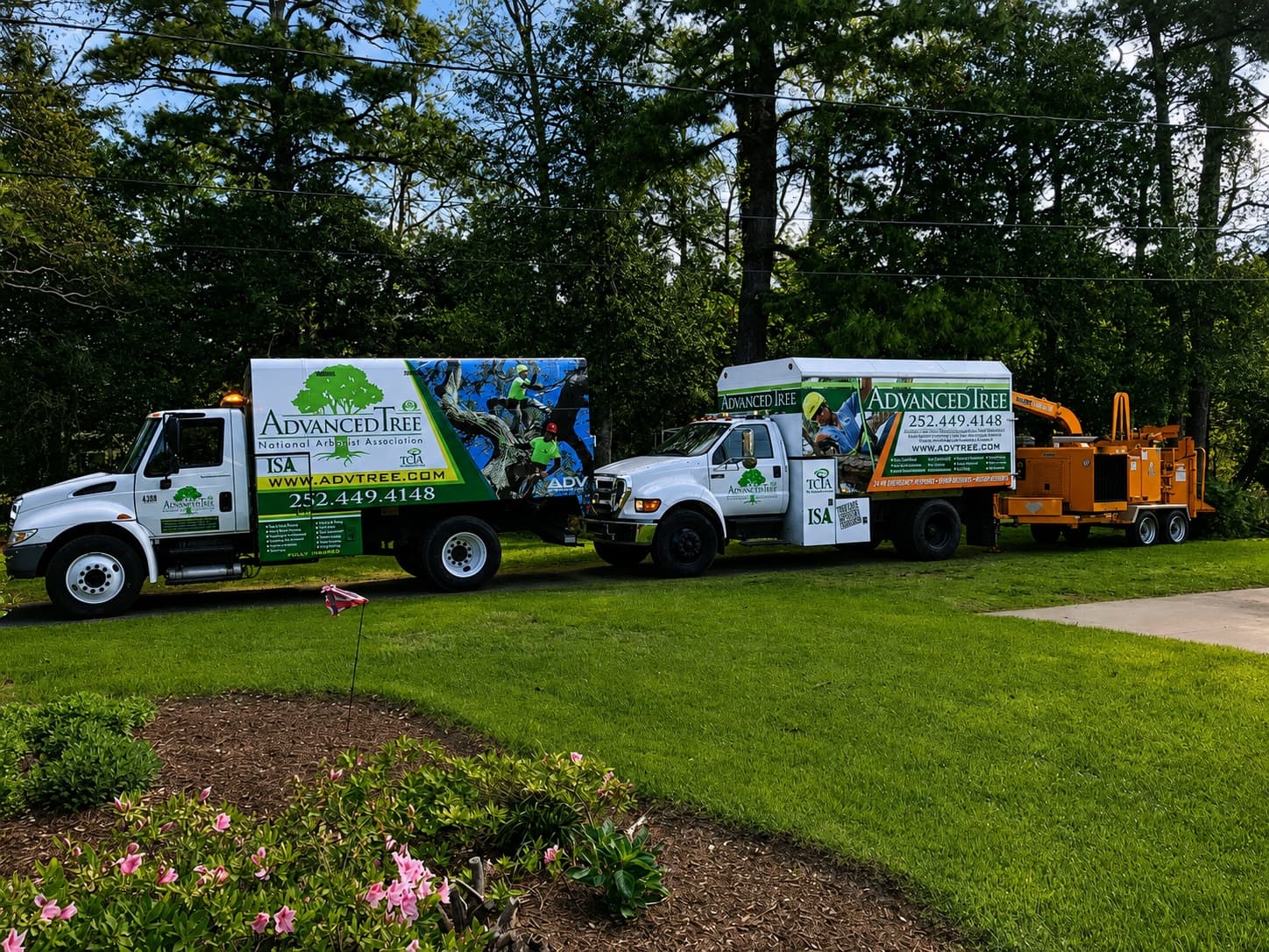 Advanced Tree service trucks and equipment at a commercial property